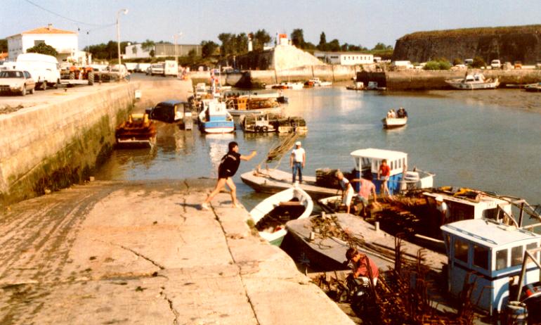 Thierry Sorlut tossing a net to his dad before hopping aboard their boat to begin a day's hard work as an oysterman.