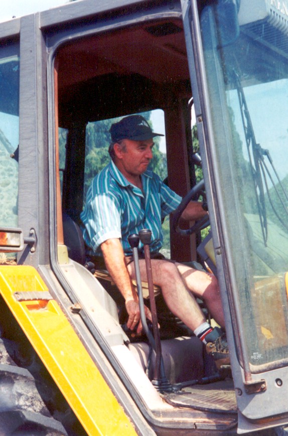 Veronique's husband, Aimé, in the saddle of his tractor, where he spends much of his days. He's cutting our hay in August.