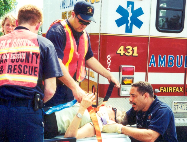 Fairfax County rescue workers tending a patient beside an ambulance