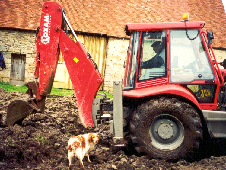 Max and his dog Horace chewing up our barnyard. He hit the remains of an 11th century building. So now I can say that our barnyard may be a disaster...