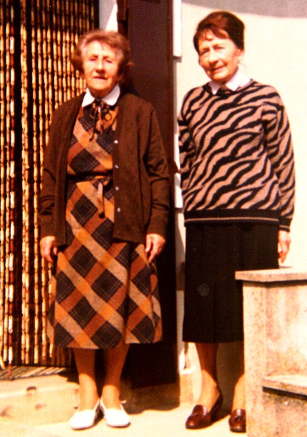 Two women standing by a doorway
