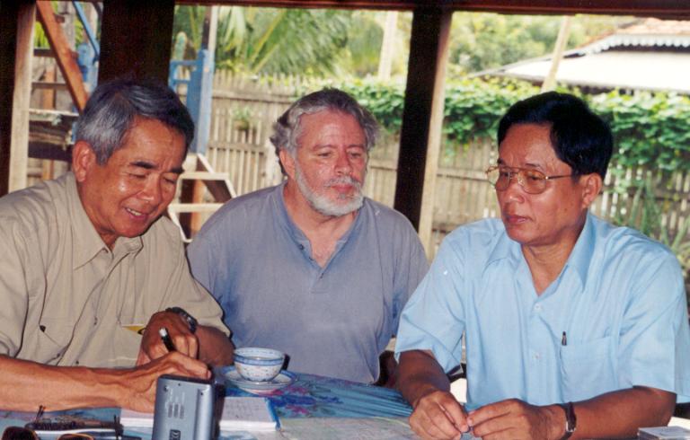 Three men seated at a table