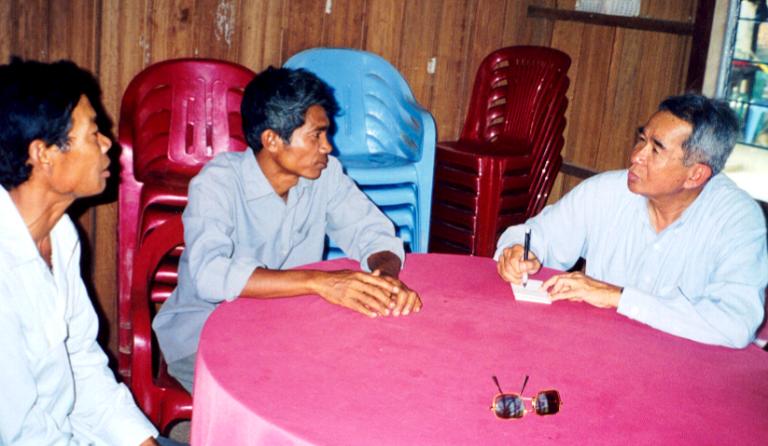 Sos Kem interviewing two farmers from the village closest to the airstrip. They had firsthand knowledge of the camp where the journalists were held.