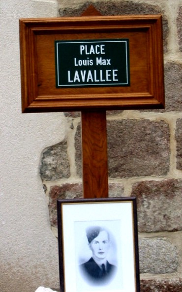Street sign reading Place Louis Max Lavallee above a framed portrait
