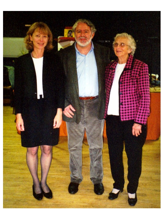 Three people standing together indoors