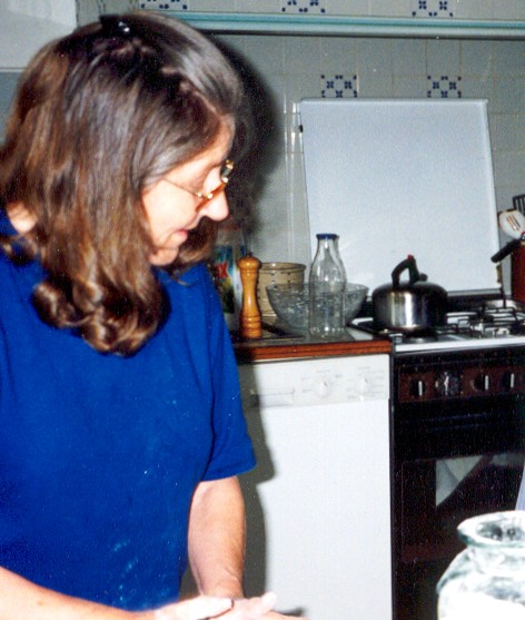 Claude working in the kitchen. There is flour in her hair, flour on her shirt. She is a hands-on cook.