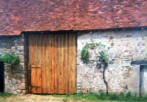 A stone barn with a wooden door