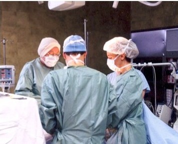 A woman of humor and informality, Odile (rear) has an easy working relationship with her surgical team.