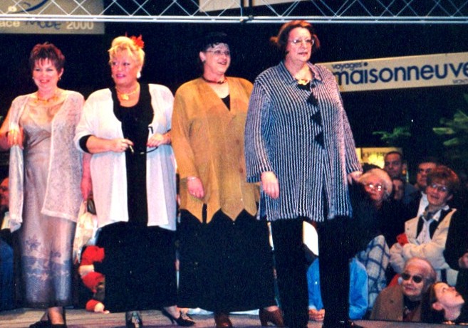 Women standing on a stage before an audience