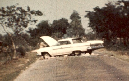 A white car stopped on a rural road