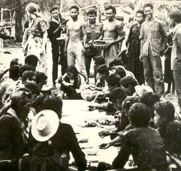 A crowd of people seated outdoors, black and white photograph