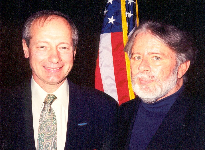 Two men in front of an American flag