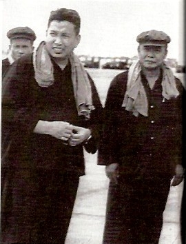 Two men in dark clothing with scarves, black and white photograph