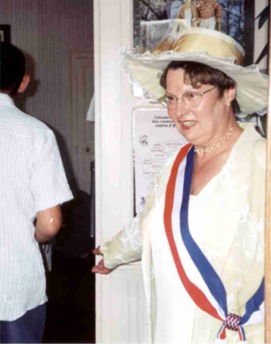 A woman wearing a tricolor sash