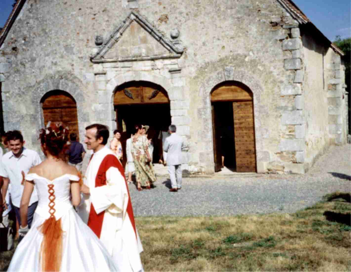 The crowd gathers at the chapel near Saint Sauvier for the religious ceremony. The bride, Sylvie, near left, talks to the church official who will...
