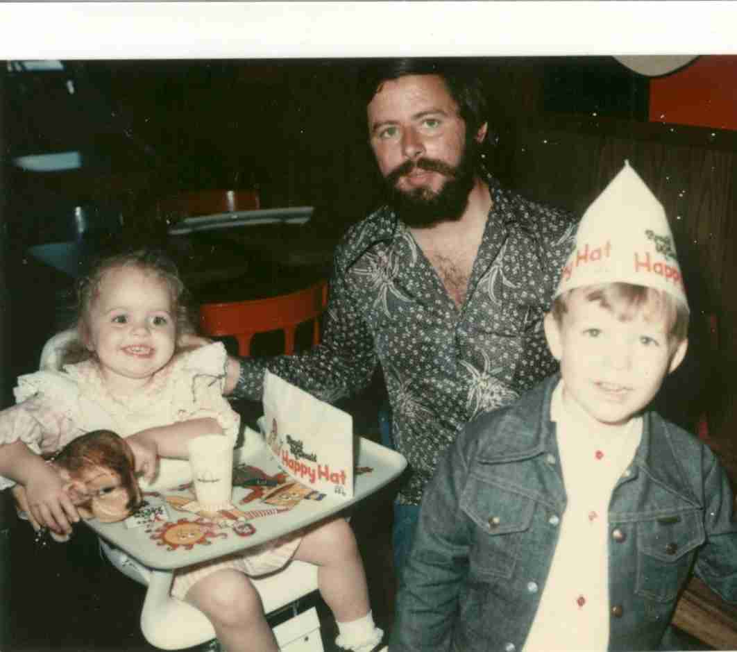 A man with two young children at a party