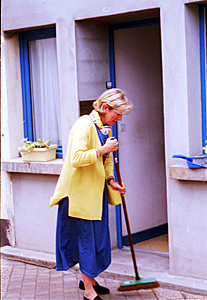 Dominique sweeping outside Edouard's office. She does all the cleaning every day at home and at the office.