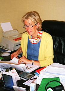 Dominique is also Edouard's secretary, bookkeeper, and general assistant.
