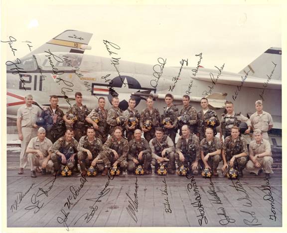 Signed group photograph of a navy squadron in front of a jet