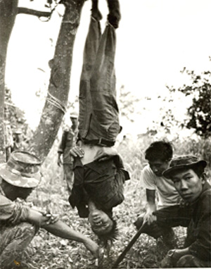 This was Sean Flynn's most famous war photo. A U.S. Special Forces team strung up and tortured a Viet Cong who had shot a little girl—1966.